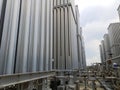 Cryogenic ambient vaporizers made of stainless steel in a mini LNG Plant along with its pipings. Royalty Free Stock Photo