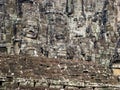 Cryptic stone faces on Cambodian wall