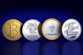 Crypto currencies: A bitcoin, Iota, Ethereum and Litecoin coin each against dark blue background