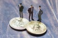 Figurines gathered around the bitcoin, an interpretation of investors