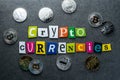 Crypto-currencies text at dark background with many Bitcoin and Litecoin coins. New virtual money business