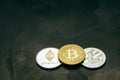 Crypto currency: bitcoin litecoin and ethereum on background from decorative plaster Royalty Free Stock Photo