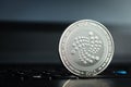 IOTA coin on laptop keyboard Royalty Free Stock Photo