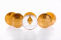 Crypto Currency Ethereum Coin Standing In Front Of Golden Bitcoins On White Background. Domination Market Concept