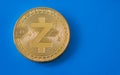 Crypto currency gold coin zcash on blue background