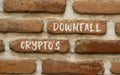 Crypto downfall symbol. Concept words Cryptos downfall on brown brick wall. Beautiful brown brick wall background. Business and