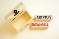 Crypto downfall symbol. Concept words Cryptos downfall on wooden blocks. Beautiful white table white background. Wooden empthy