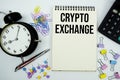 Crypto Exchange text written on notepad with calculator and alarm clock Royalty Free Stock Photo