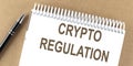 CRYPTO REGULATION text on a notepad with pen, business Royalty Free Stock Photo