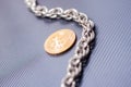Cryptocoin and a silver chain Royalty Free Stock Photo