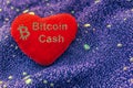 The cryptocurrency Bitcoin Cash symbol is a red plush heart with a neon background. BCH Royalty Free Stock Photo