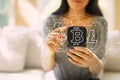 Cryptocurrency - Bitcoin, Ethereum, Litecoin with woman using a smartphone