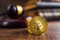 Cryptocurrency. Bitcoin virtual money. Golden coins and judge gavel