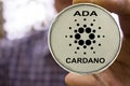 Cryptocurrency Cardano in the man`s hand