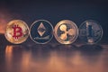 TOP of Cryptocurrencies. Bitcoin, Ethereum, Ripple, Litecoin on brown wood