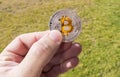 Cryptocurrency coins in a hand; Bitcoin Royalty Free Stock Photo