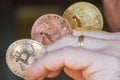 Cryptocurrency coins in a hand; Bitcoin Royalty Free Stock Photo