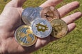 Cryptocurrency coins in a hand; Bitcoin, Ripple, Dash Royalty Free Stock Photo