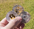 Cryptocurrency coins in a hand; Bitcoin, Ripple, Dash Royalty Free Stock Photo