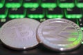 Cryptocurrency coins on illuminated computer keyboard