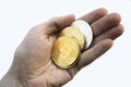 Cryptocurrency coins on a white background in a hand. Bitcoin Litecoin.