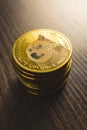 Cryptocurrency. Dogecoin virtual money. Golden coin on wooden table