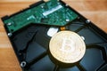 Cryptocurrency Golden Bitcoin on hard disk drive Royalty Free Stock Photo