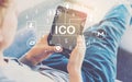 Cryptocurrency ICO theme with man using a tablet Royalty Free Stock Photo