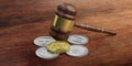 Cryptocurrency law. Gavel and variety of virtual coins on wooden background. 3d illustration