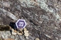 Cryptocurrency mining emercoin in a rock background