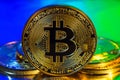 Cryptocurrency physical golden bitcoin coin on colorful background