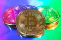 Cryptocurrency physical golden bitcoin coin on colorful background