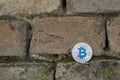 Cryptocurrency physical silver bitcoin coin on the brick wall