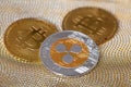 cryptocurrency Ripple coin ( XRP token) and bitcoin on golden background
