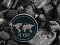 Cryptocurrency XRP coin lies on coal. Mining and Energy for mining