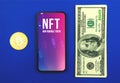 Cryptographic NFT, non fungible token logo on the screen of modern mobile phone, office blue desk with money and crypto