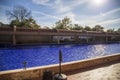 the crypts of Martin Luther King and Coretta Scott King with a pool of rippling water with blue tile, a red brick footpath