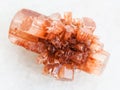 crystal of Aragonite gemstone on white marble