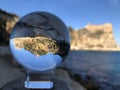Crystal ball and coastal landscape, creative refraction photography