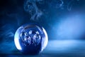 Crystal ball in dark blue smokey background
