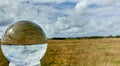 Crystal ball with the flat landscape of the North Sea island Sylt with a lighthouse