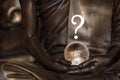 Crystal ball in the hands of a monk surmounted by a question mark, predicting the future Royalty Free Stock Photo