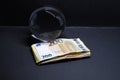 Crystal ball lies behind a stack of money with euro banknotes Royalty Free Stock Photo