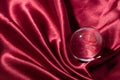 Crystal ball on red silk textile Royalty Free Stock Photo