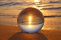 Crystal ball on the sand on the beach at sunset Royalty Free Stock Photo