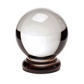 Crystal ball sitting on wooden stand reflecting light Royalty Free Stock Photo