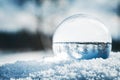 Crystal ball on white snow, wide-angle winter landscape reflection Royalty Free Stock Photo