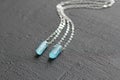 Crystal blue aquamarine beryl on a silver chain. Pendant aquamarine, pendant, decoration on the neck. Natural blue aquamarine on a Royalty Free Stock Photo