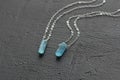 Crystal blue aquamarine beryl on a silver chain. Pendant aquamarine, pendant, decoration on the neck. Natural blue aquamarine on a Royalty Free Stock Photo