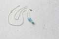 Crystal blue aquamarine beryl on a silver chain. Pendant aquamarine, pendant, decoration on the neck. Natural blue aquamarine on a